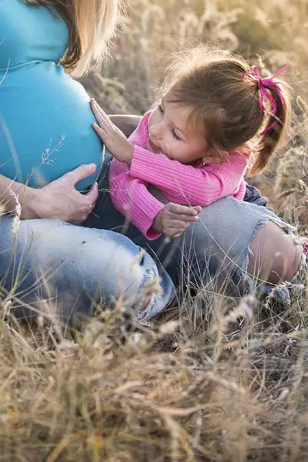 pregnant woman sitting with her child